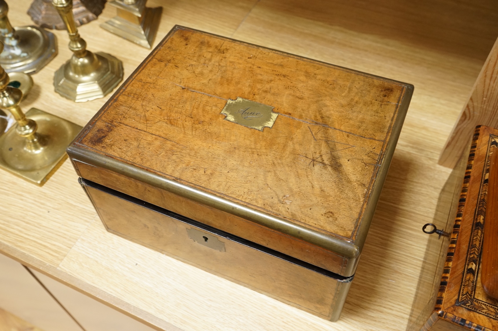 A walnut and German bandwork tea caddy, a brass bound walnut writing slope and an Art Deco Killarney inlaid trinket box, largest 15cm high, 30cm wide.